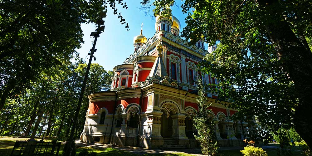 Golden onion domes of Shipka Memorial Church against Balkan Mountains
